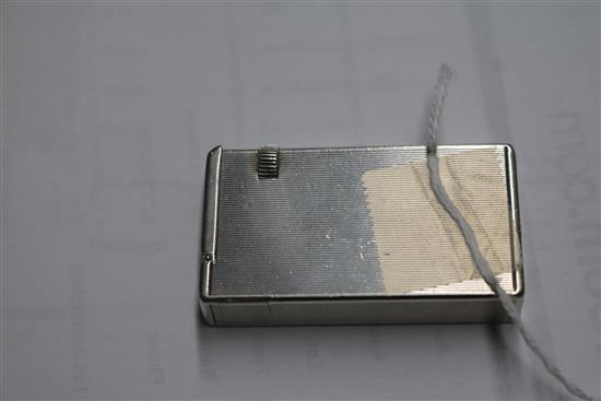 A Dunhill engine-turned silver cigarette lighter, patent no. 440072, London, 1948, 59mm.